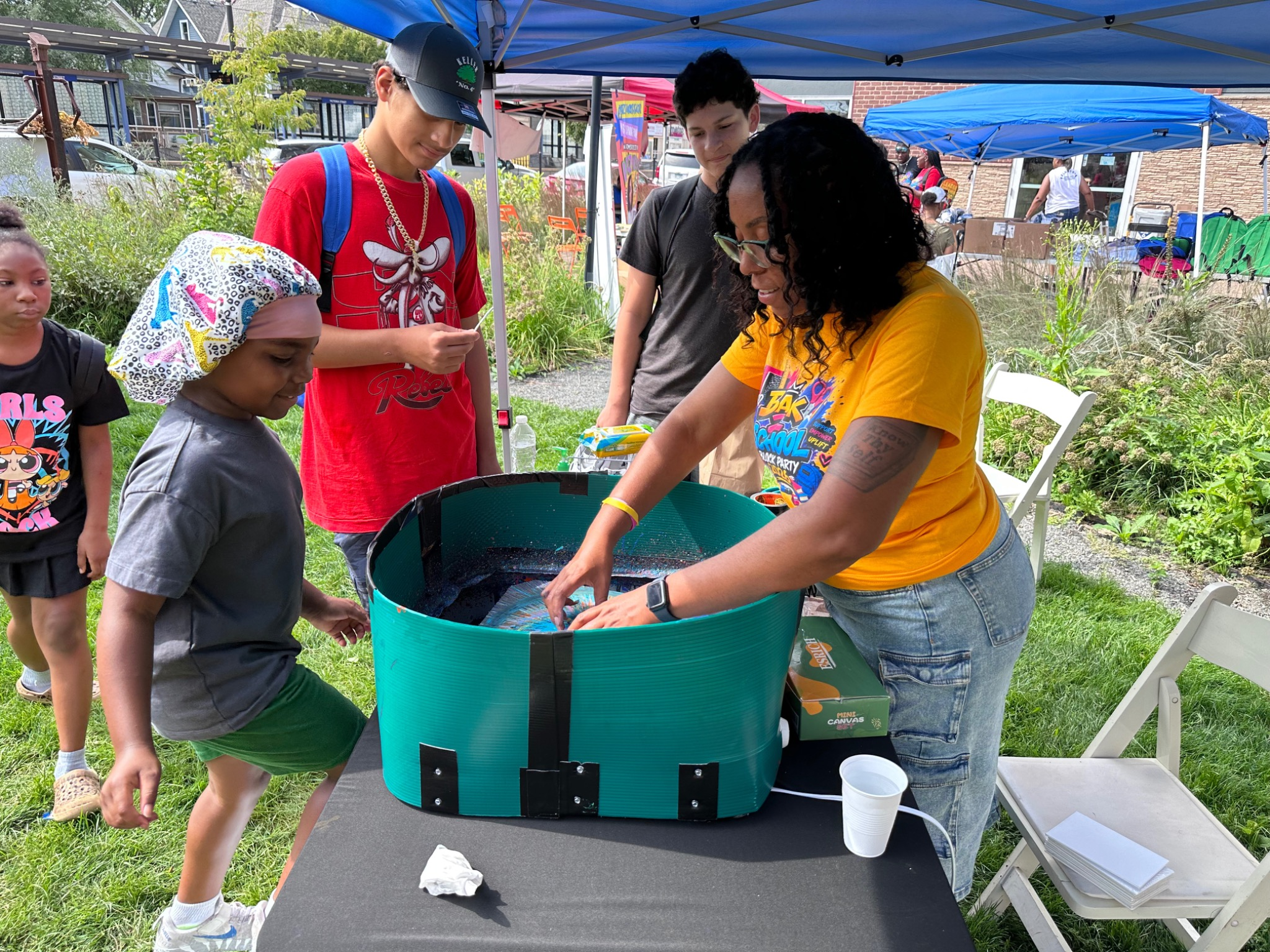 Youth and community members participating in activities at the Fresh and Fly Bash