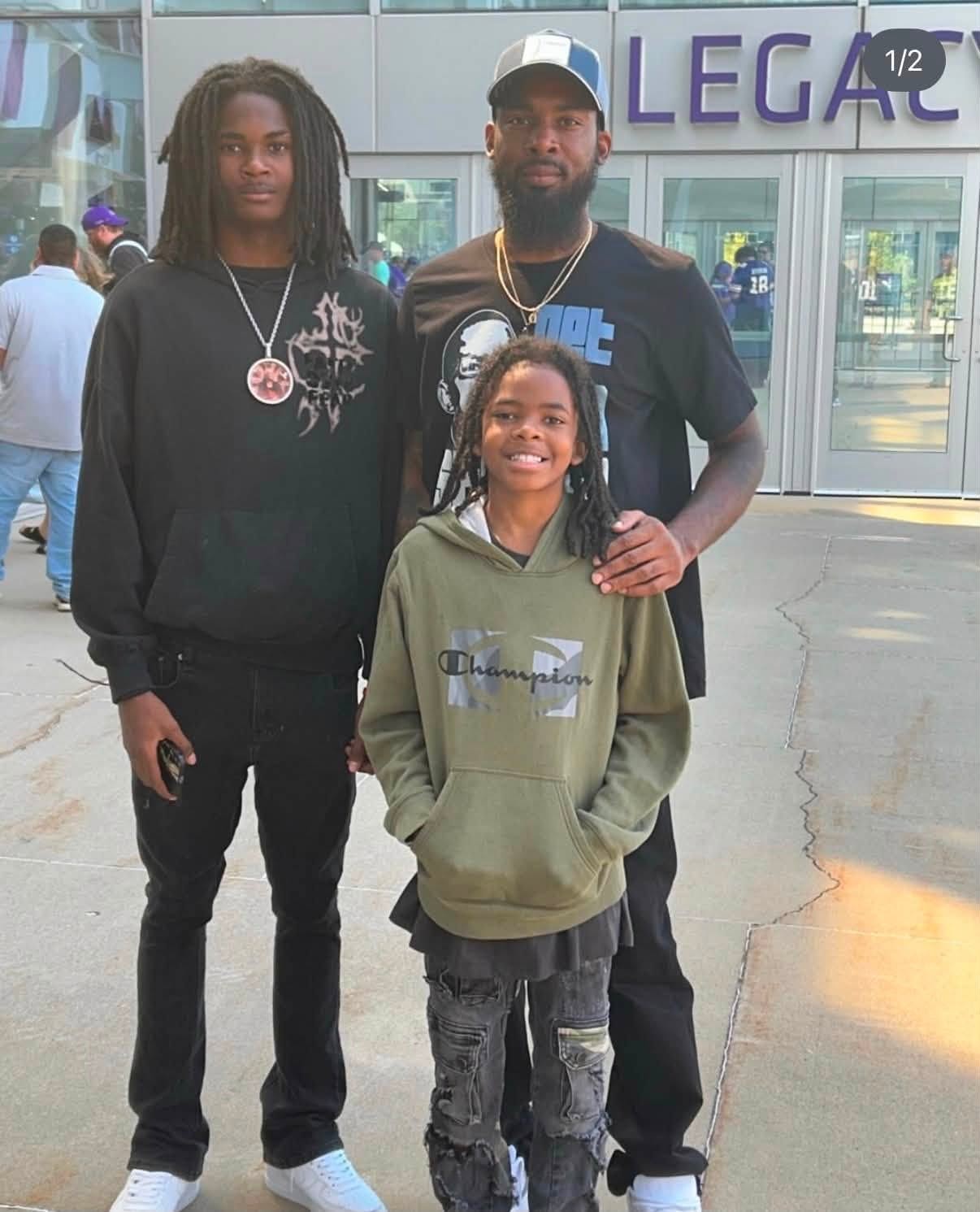 DJ with family members outside a sports venue